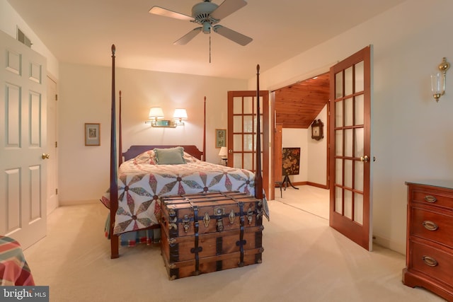 bedroom featuring french doors, light carpet, and baseboards