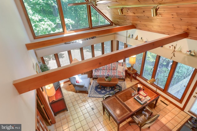 living area with ceiling fan and light tile patterned floors