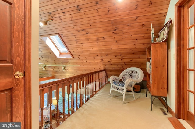 living area with carpet floors, a skylight, and wooden walls