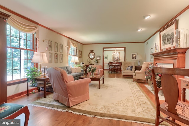 living room with ornamental molding, a wealth of natural light, and wood finished floors