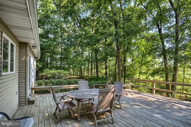 wooden terrace with outdoor dining space