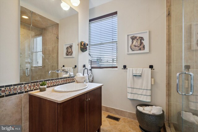 bathroom featuring a shower with door, tile patterned flooring, and vanity