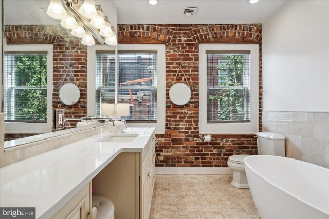 bathroom with plus walk in shower, tile patterned floors, and vanity