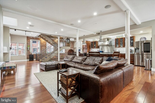 staircase featuring beam ceiling and wood-type flooring