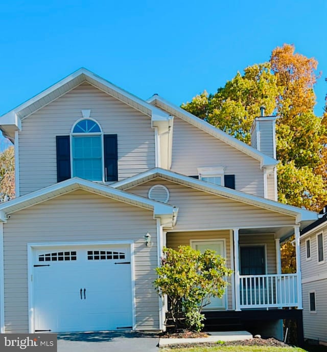 view of front of house featuring a garage and a porch