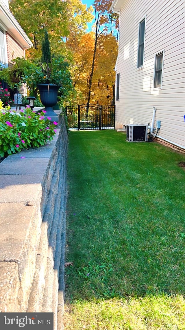 view of yard with central air condition unit