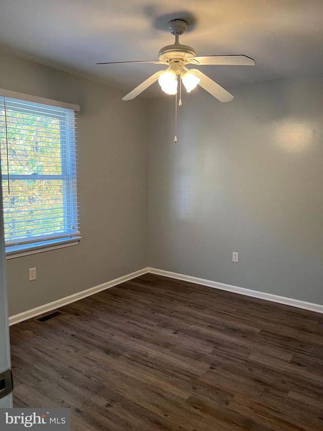 unfurnished room with ceiling fan and dark hardwood / wood-style flooring