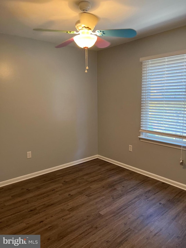 unfurnished room featuring ceiling fan and dark hardwood / wood-style flooring