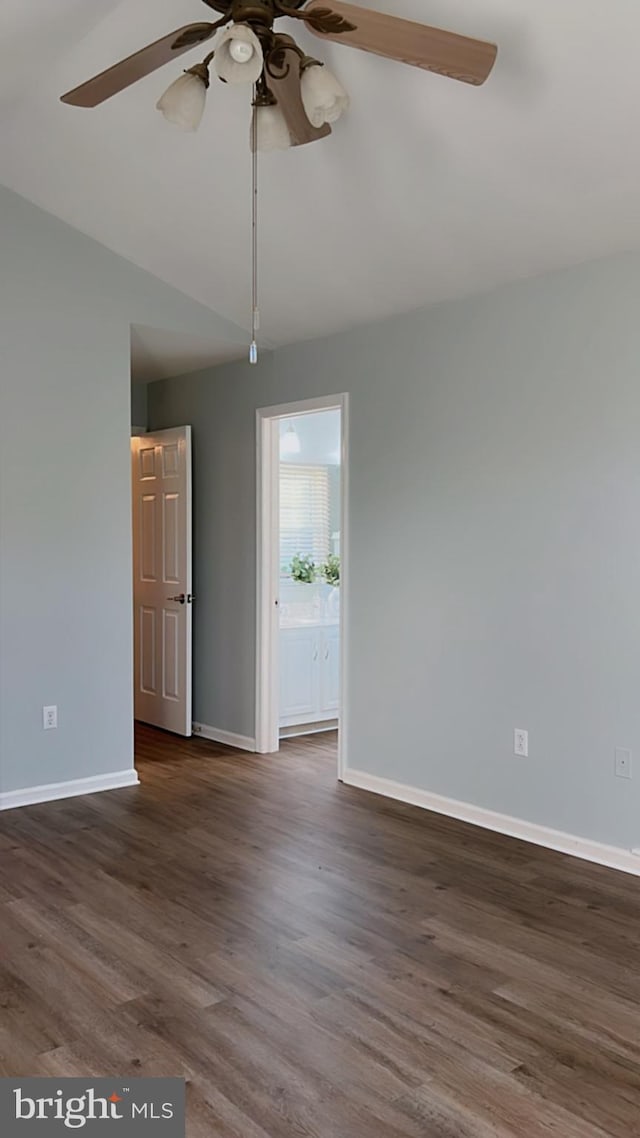 empty room with dark wood-type flooring and ceiling fan