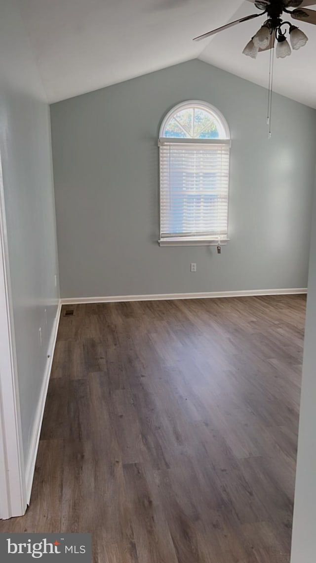 spare room featuring vaulted ceiling, dark hardwood / wood-style flooring, and ceiling fan