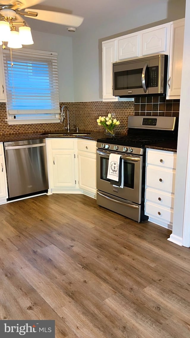 kitchen featuring white cabinets, hardwood / wood-style flooring, stainless steel appliances, and sink