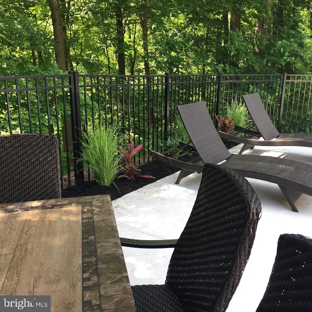 view of patio featuring fence