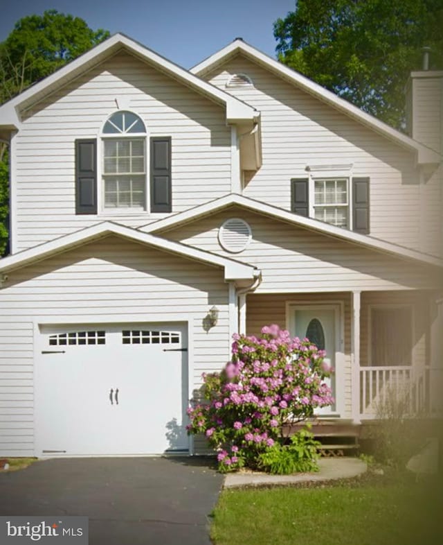 traditional home featuring an attached garage and a chimney