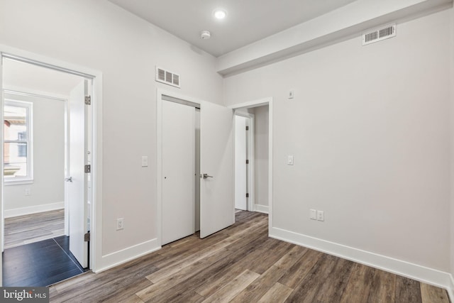 unfurnished bedroom with wood-type flooring