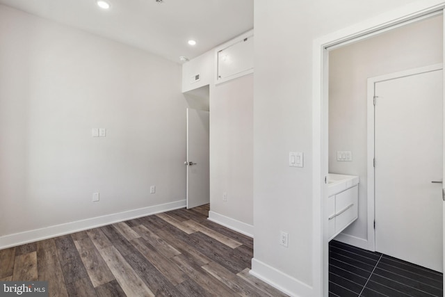 unfurnished bedroom with dark hardwood / wood-style flooring