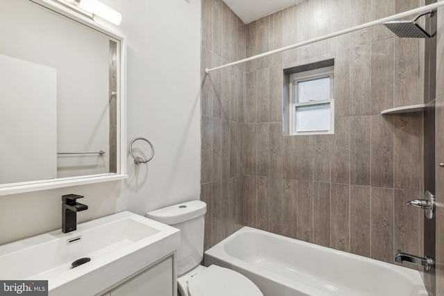 full bathroom with tiled shower / bath combo, toilet, and vanity