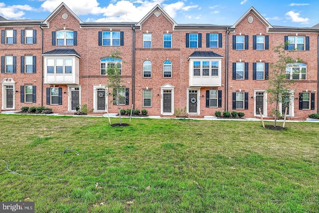 view of property featuring a front lawn