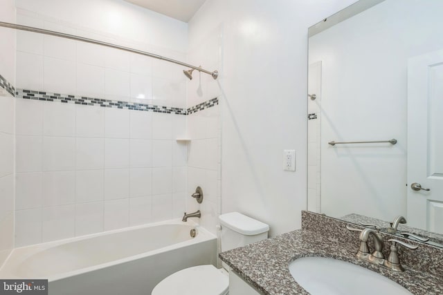 bathroom featuring toilet, bathing tub / shower combination, and vanity