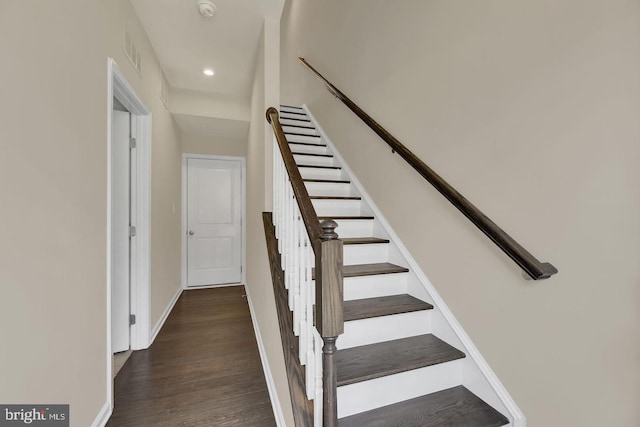 staircase with wood-type flooring