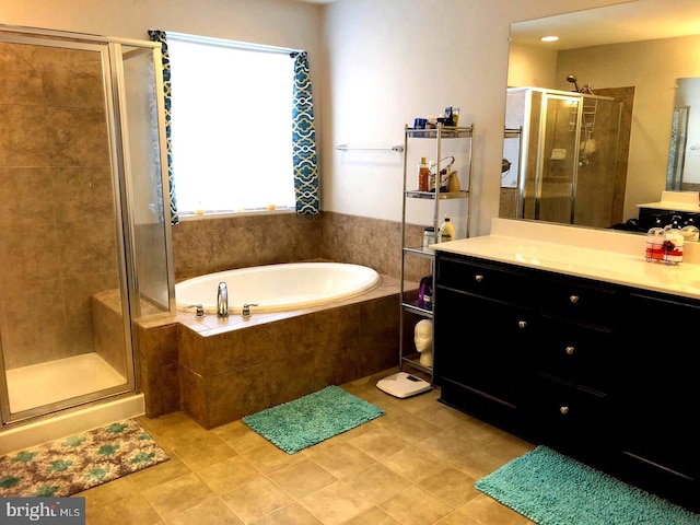 bathroom with tile patterned floors, vanity, and independent shower and bath