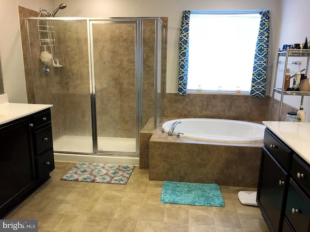 bathroom with tile patterned floors, plus walk in shower, and vanity