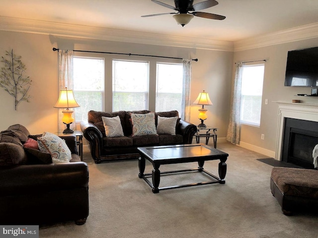 carpeted living room featuring ceiling fan and ornamental molding