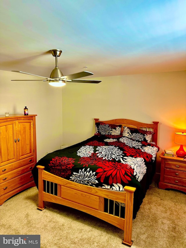 bedroom featuring light colored carpet and ceiling fan