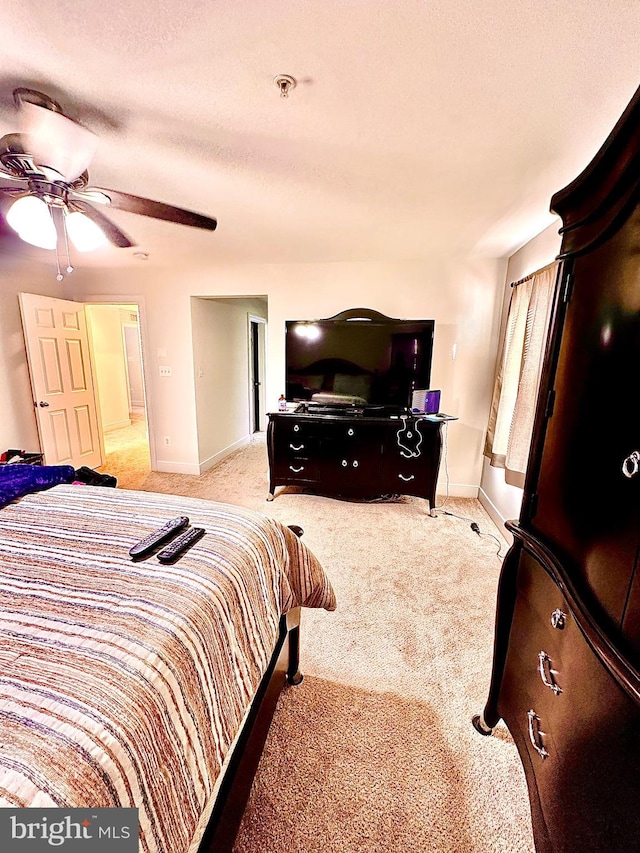 bedroom with light carpet and ceiling fan