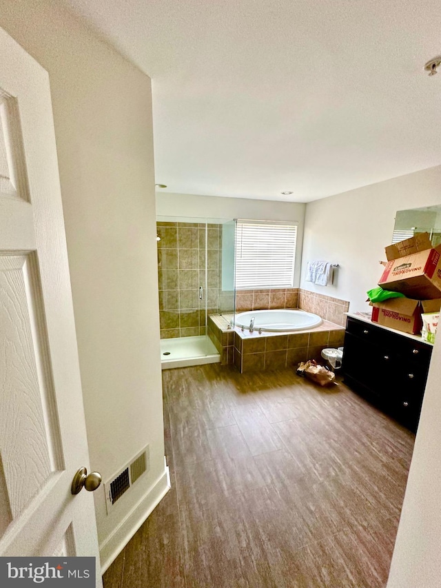 bathroom with vanity, a textured ceiling, and shower with separate bathtub