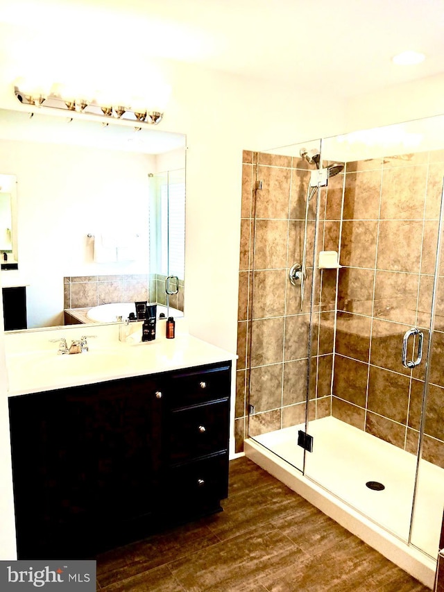 bathroom featuring hardwood / wood-style floors, sink, and walk in shower