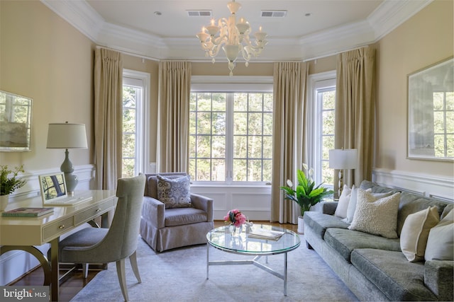 living area featuring a healthy amount of sunlight, visible vents, a decorative wall, and crown molding