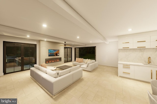 living room with a large fireplace, baseboards, beam ceiling, and recessed lighting