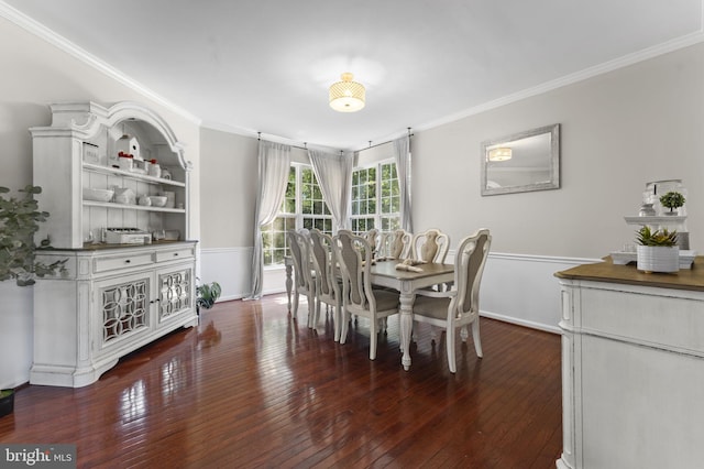 dining space featuring baseboards, dark wood-type flooring, and crown molding