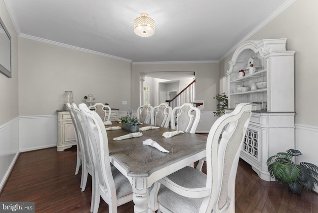 dining room with stairway, baseboards, ornamental molding, and dark wood-type flooring