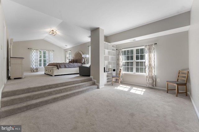 carpeted bedroom featuring lofted ceiling