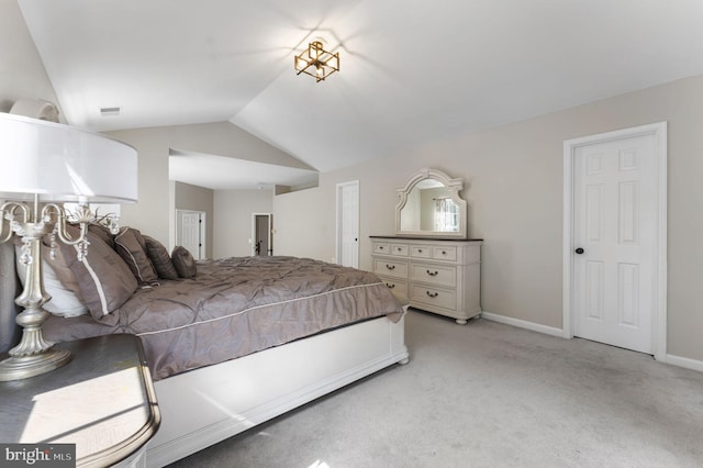 bedroom with lofted ceiling, baseboards, and light colored carpet