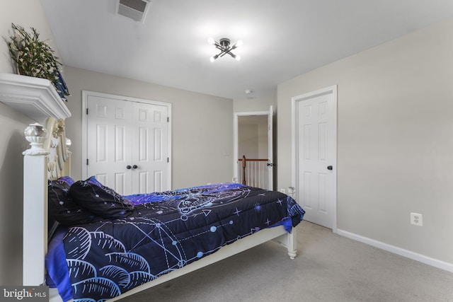 bedroom featuring carpet, a closet, visible vents, and baseboards