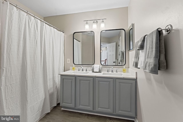 bathroom with hardwood / wood-style flooring, curtained shower, and vanity