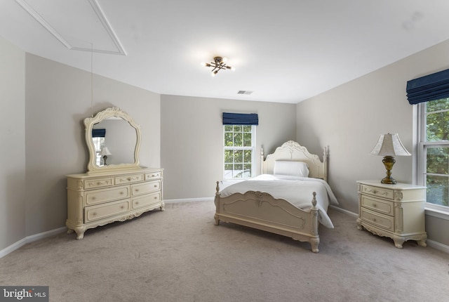 bedroom featuring light carpet, attic access, visible vents, and baseboards