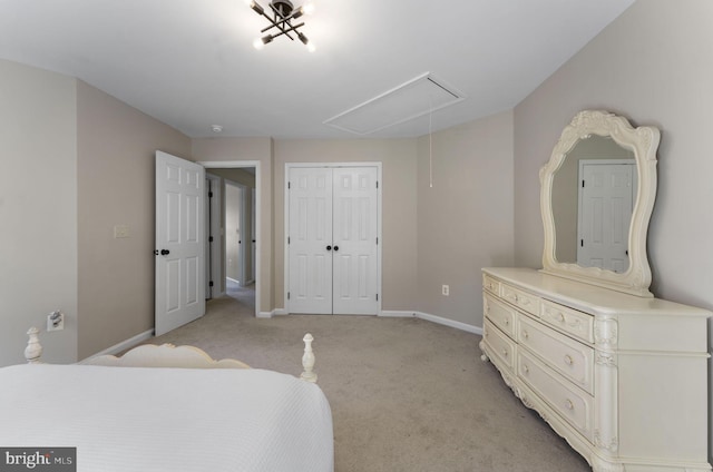 bedroom featuring light carpet, a closet, attic access, and baseboards