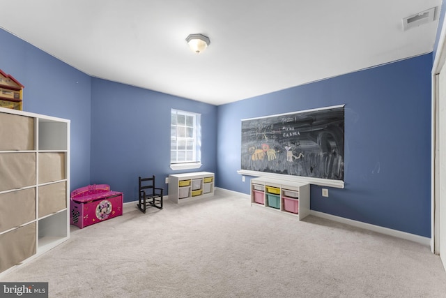 recreation room with carpet, visible vents, and baseboards