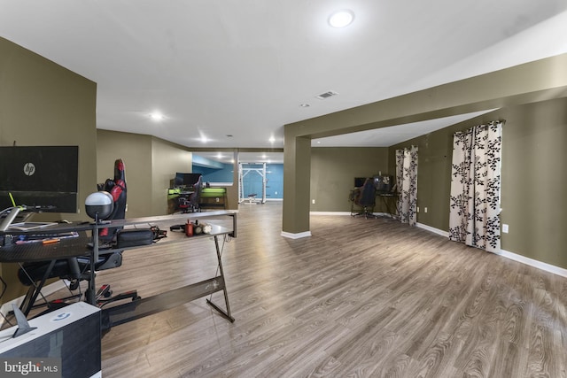 exercise area featuring recessed lighting, wood finished floors, visible vents, and baseboards