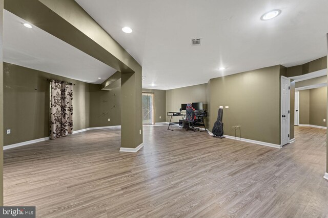 basement with dark hardwood / wood-style flooring