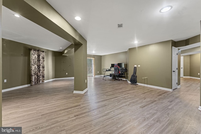 interior space featuring light wood-style floors, visible vents, and baseboards