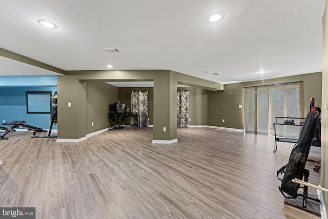 workout area featuring baseboards, recessed lighting, visible vents, and light wood-style floors