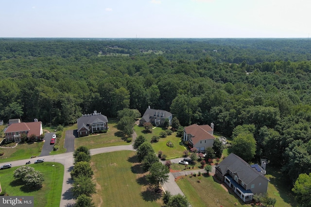 birds eye view of property featuring a forest view and a residential view