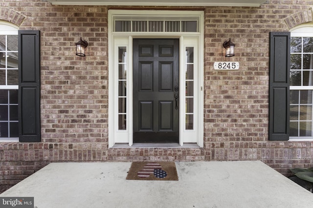 entrance to property with brick siding