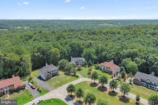 aerial view featuring a forest view and a residential view