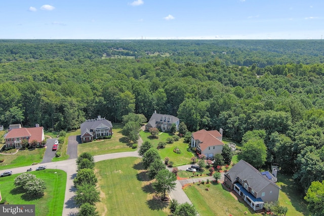 bird's eye view featuring a residential view and a wooded view