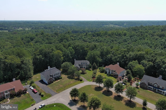 birds eye view of property with a wooded view and a residential view